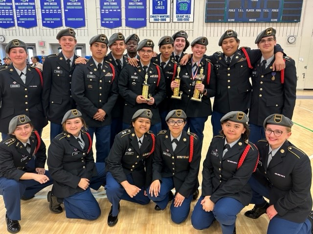 Image of JROTC Drill Team with their trophies